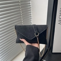 Minimalist black matte envelope crossbody bag with gold chain and ring detail - Black