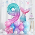 Detail of 9th birthday mermaid balloon set with teal tail and shell foil decorations - Number 9