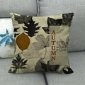 Detail of autumn linen pillowcase with maple leaves and 'AUTUMN' quote on gray sofa - AUTUMN Quote (7)