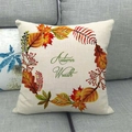 Close-up of linen pillowcase with autumn wreath design on a grey sofa setting - Autumn Wreath Green Font Style (13)