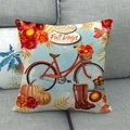 Detail of linen pillow cover with fall bike, pumpkin graphics on a grey sofa - Red Bicycle Pumpkin Fall Days Style