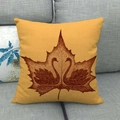 Detailed texture of linen autumn maple leaf pillow cover on a grey fabric sofa - Ginger Swan Maple Style