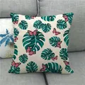 Tropical monstera leaf and butterfly print linen pillow cover on a grey sofa - Monstera Leaves with Pink Butterflies (10)