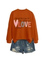 Detail of orange crewneck sweatshirt featuring stylish black LOVE script and denim shorts - Burnt Orange Sweatshirt (Black Pattern)