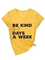 Detail of V-neck cotton T-shirt featuring side-tie knot and BE KIND printed slogan - S / Yellow (Black Graphics)