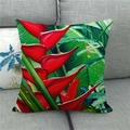 Linen pillow cover with tropical red flower and green leaf design on a gray sofa - Tropical Plant Heliconia Style (10)