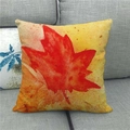 Detailed texture of autumn maple leaf linen pillowcase on a grey fabric sofa - Orange-Yellow Watercolor Maple Style