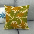 Detail shot of linen pillowcase with maple leaf prints on a soft grey fabric sofa - Green and Withered Oak Leaves Style