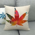Close-up of linen pillowcase with colorful maple leaf print on a grey sofa - Colorful Artistic Leaf Style