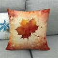 Detailed texture of autumn maple leaf linen pillow cover on a modern grey fabric sofa - Artistic Gradient Orange-Red Maple Style