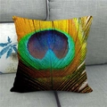Detailed texture of peacock feather linen pillowcase on a grey fabric sofa - Realistic Peacock Blue Emerald Style 15 (15)