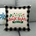 Close-up of Christmas linen pillowcase on sofa with buffalo plaid and reindeer print - Reindeer Event Style (1)