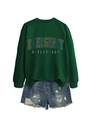 Flat lay of a green emergency department sweatshirt and distressed blue denim shorts - Dark Green