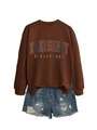 Flat lay of brown pullover sweatshirt with emergency department print and ripped denim shorts - Coffee