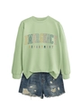 Detail of light green sweatshirt with text print and distressed denim shorts - Olive Green