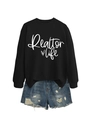 Flat lay of a black Realtor Life sweatshirt paired with distressed denim shorts - Black (White Font)