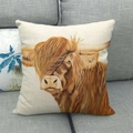 Square beige pillow cover featuring a realistic highland cow print on a soft grey sofa - Scottish Highland Cow (3)