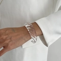 Macro shot of stylish transparent resin spiral bangle on white fashion blazer - Transparent Color (0158)