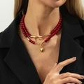 Detail of red beaded necklace with golden tube accent and heart pendant on OT toggle clasp - Layered Red Beads Heart Style (06912) / Gold + Red-06912