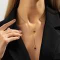 Vintage Y-shaped gold sunburst necklace with tiger eye stone pendant on a black blazer - Gold Y-Shaped Sun Pendant Necklace (07522)