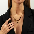 Macro shot of gold-plated Y-shaped double necklace featuring natural tiger eye stone pendant - Gold Double Layer Tiger Eye Oval Necklace (07524)