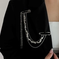 Detail of silver tassel chain brooch with stars on black suit jacket lapel - Silver Tassel Style (00347)