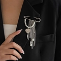 Detailed macro view of a silver safety pin brooch with heart charm and pearl fringe tassels - Artificial Pearl Heart Tassel Brooch (0346) / 03 White K (0346)