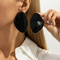 Detail of large black resin stud earrings with irregular gold-tone metal frames on ears - Gold Glossy Black Irregular Geometric Stud Earrings (03861)