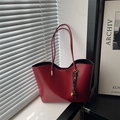 Red leather tote bag with a metallic bell charm placed by a modern window with soft shadows - Red (With Pendant)
