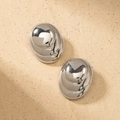 Close-up of geometric oval spiral silver earrings with a polished mirror finish surface - Silver