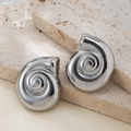 Detailed view of silver seashell earrings on a natural beige travertine stone background - White Gold
