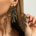 Close-up of golden leaf drop earrings featuring micro-paved black crystals on a model - Antique Gold+Gun Black-03909 (Layered Leaf)