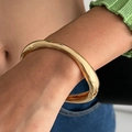 Polished thick gold concave spring cuff bracelet with a glossy mirror finish for women - Smooth Round Arc Style (02430-Gold)