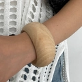 Wide wooden cuff bracelet with natural grain texture shown on model for a bohemian look - Wide Natural Wood Color
