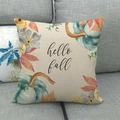Detail of linen pillow cover with pumpkins and Hello Fall text on a grey sofa - Light Green Pumpkin Leaves (9)