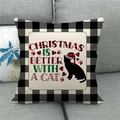 Detailtextur eines Leinen-Weihnachtskissenbezugs mit Katzen-Silhouette auf grauem Sofa - Weihnachtskatze (2)