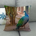 Peacock oil painting cushion cover shown on a grey sofa with vibrant linen texture - Forest Walking Blue Peacock (2)