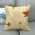 Detail showing natural linen texture and autumn maple leaf prints on a square cushion cover - Beige Woven Fall Leaves (16) / 45x45cm