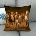 Linen pillowcase with vintage running horses oil painting on a gray sofa - Vintage Warm Brown Earth Tone Herd (8)
