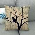 Close-up of linen pillowcase with cat and bird silhouette art on a gray sofa - 45x45cm / Old Wood Moon Shadow Cat (12)