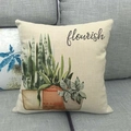 Close-up of linen pillow cover with watercolor plant print on a grey fabric sofa - Flourish Watercolor Potted (2)