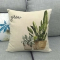 Detail of linen pillowcase with watercolor cactus print and grow text on a sofa - Grow Tropical Mix (3)