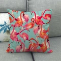 Close-up of pink flamingo pattern on linen throw pillow cover on a grey sofa - High Saturation Flamingo Group (6)