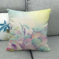Close-up of linen cushion cover showing dream watercolor unicorn and sea shell prints - Dreamy Watercolor Unicorn Cloud Style (3)
