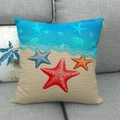 Close-up of square linen pillowcase with starfish and seashell patterns on a gray sofa - Colorful Seastar Beach (10)