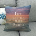 Close-up of linen pillow cover with beach sunset print on a grey sofa - 45x45cm / Sunset Life Style (4)