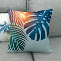 Linen pillow cover with tropical palm and monstera leaves on a gray fabric sofa - 18x18 Inch / Sunset Orange Deep Blue Gradient Leaves (10)