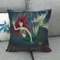 Detail of mermaid linen pillowcase on a grey sofa showing the underwater world design - Red Hair Mermaid Illustration Style (16)