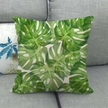 Close-up of linen pillowcase with watercolor monstera leaf print on a grey sofa - Green Monstera Leaf Style (2)