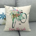 Watercolor bicycle linen pillowcase on grey sofa with Enjoy the ride quote - Cyan Bicycle with Flower Basket (Style 1)